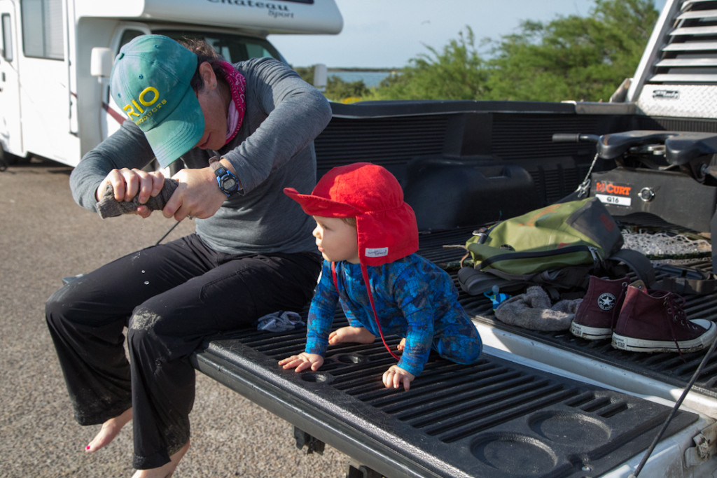 George helping Aimee wring out her socks after a day of wading.